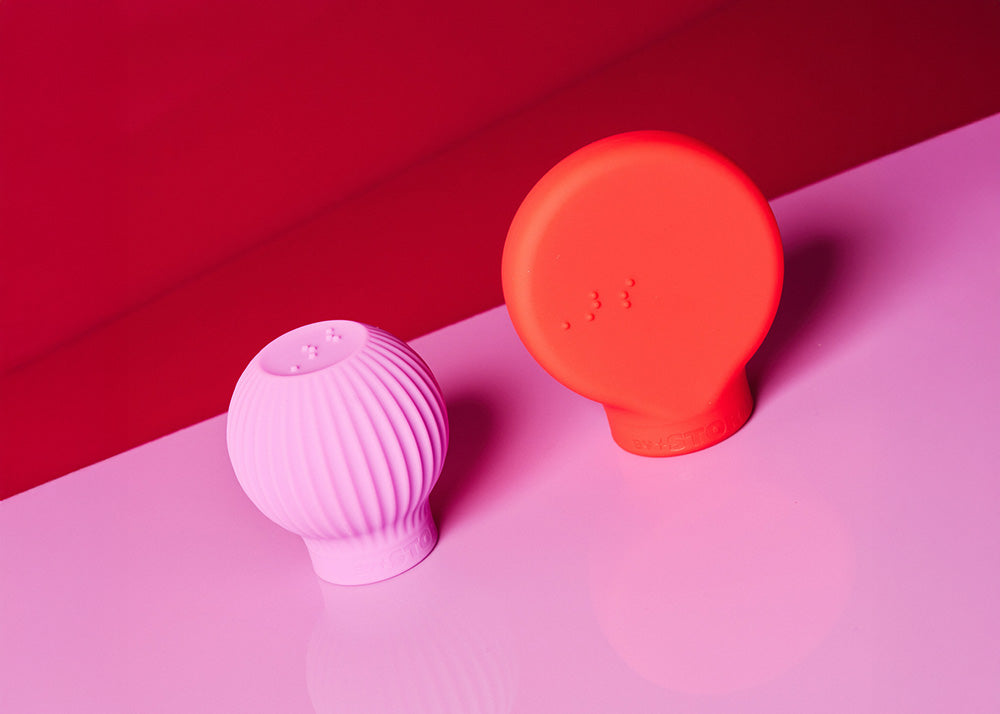 Pink and red silicone bulb-shaped makeup grippers on a pink and red background
