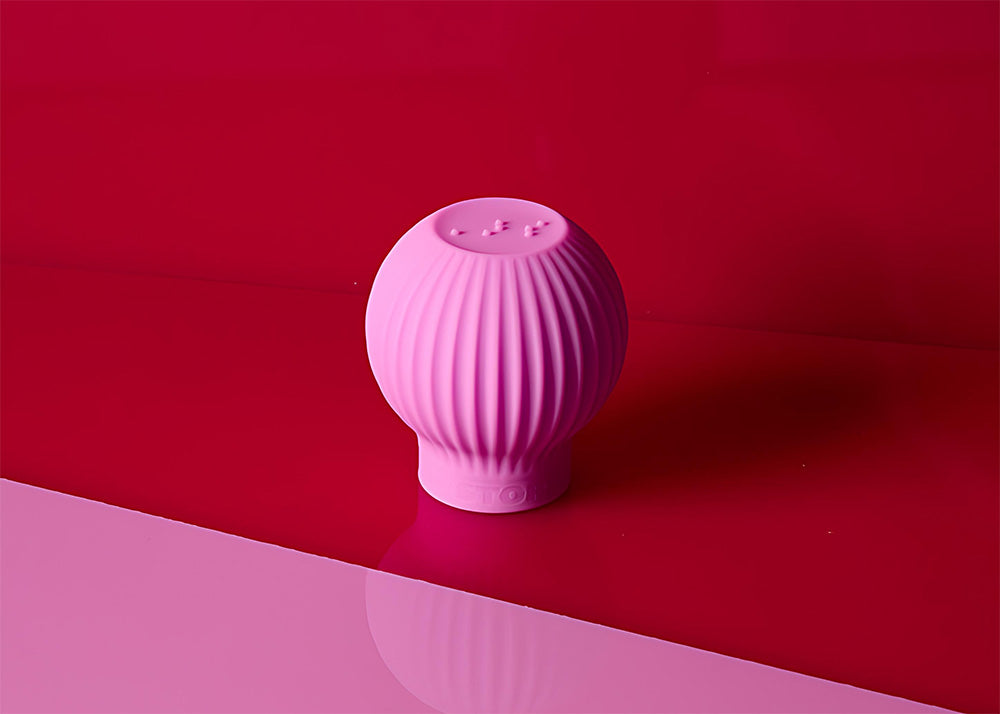 Pink makeup gripper on a pink and red background