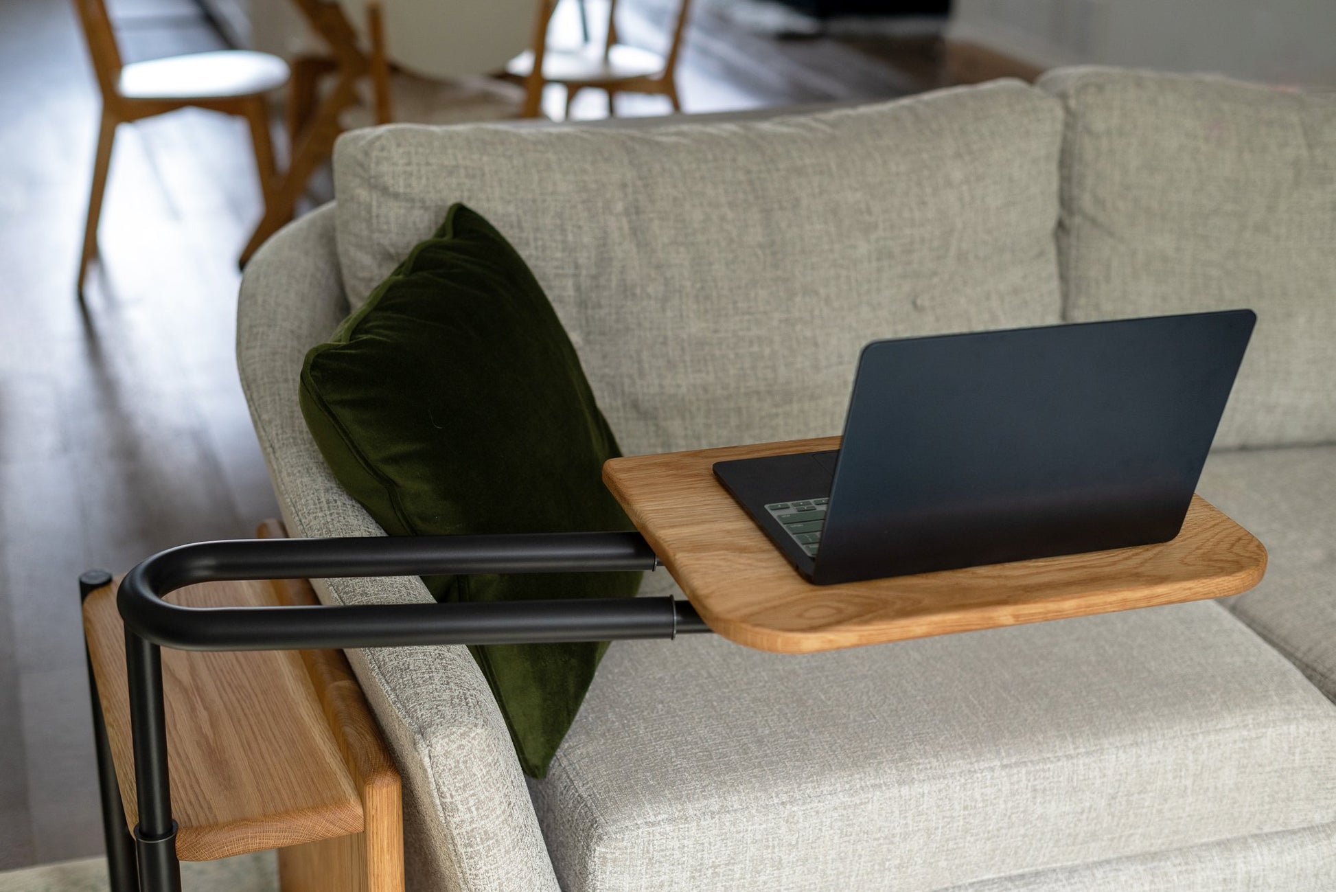 Front view of the Corbel Adjustable Side Table tray with an open laptop on it.