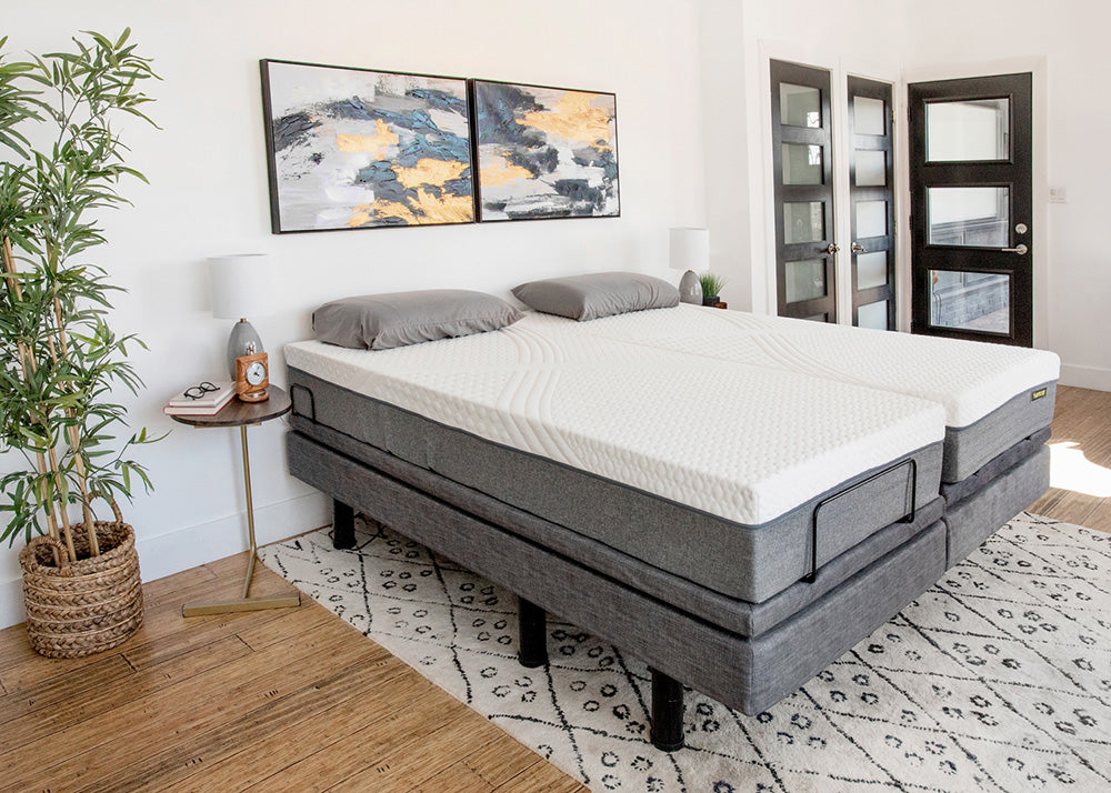 Gray adjustable bed in a bedroom setting with decor elements.