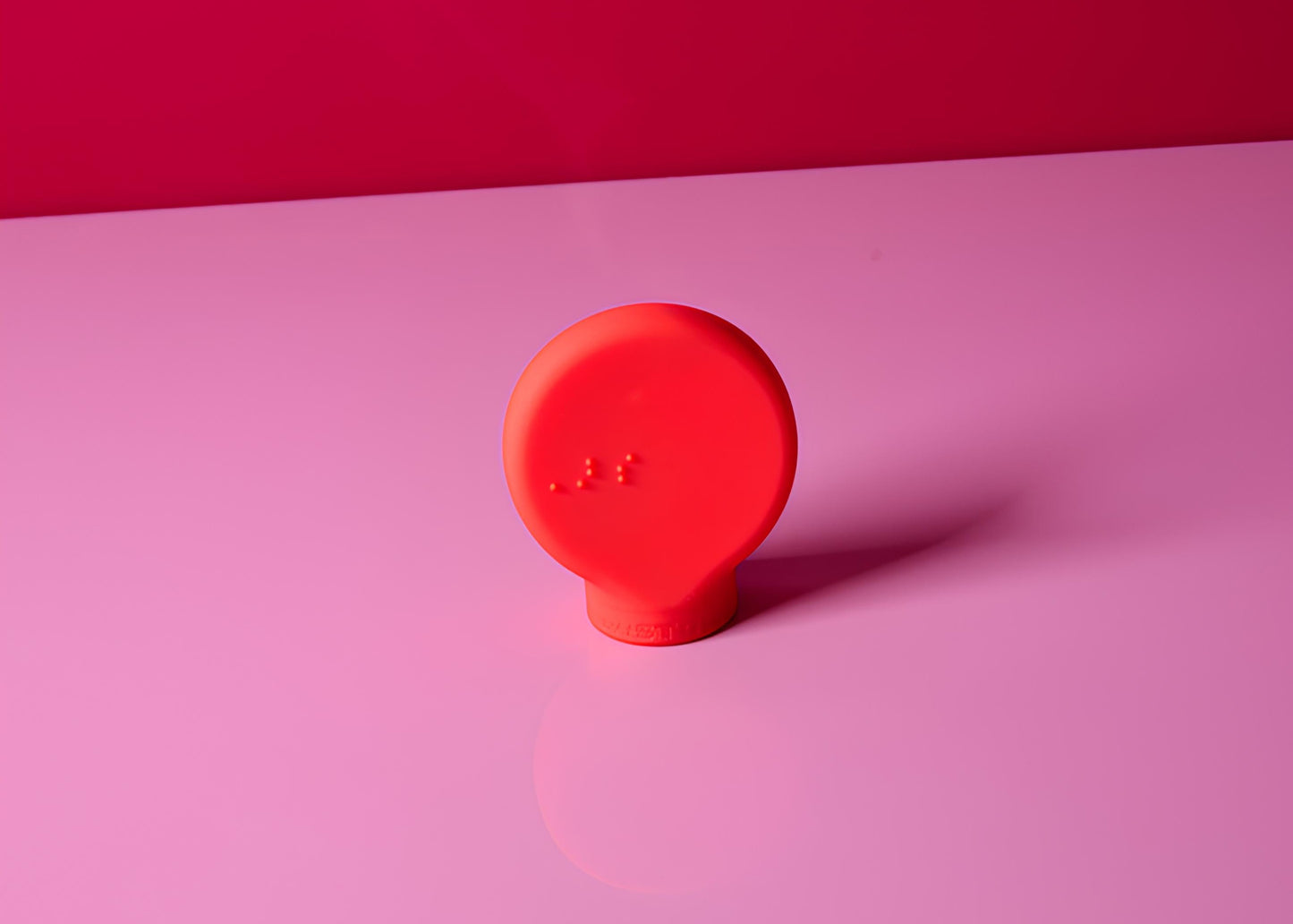 Red makeup gripper on a pink background