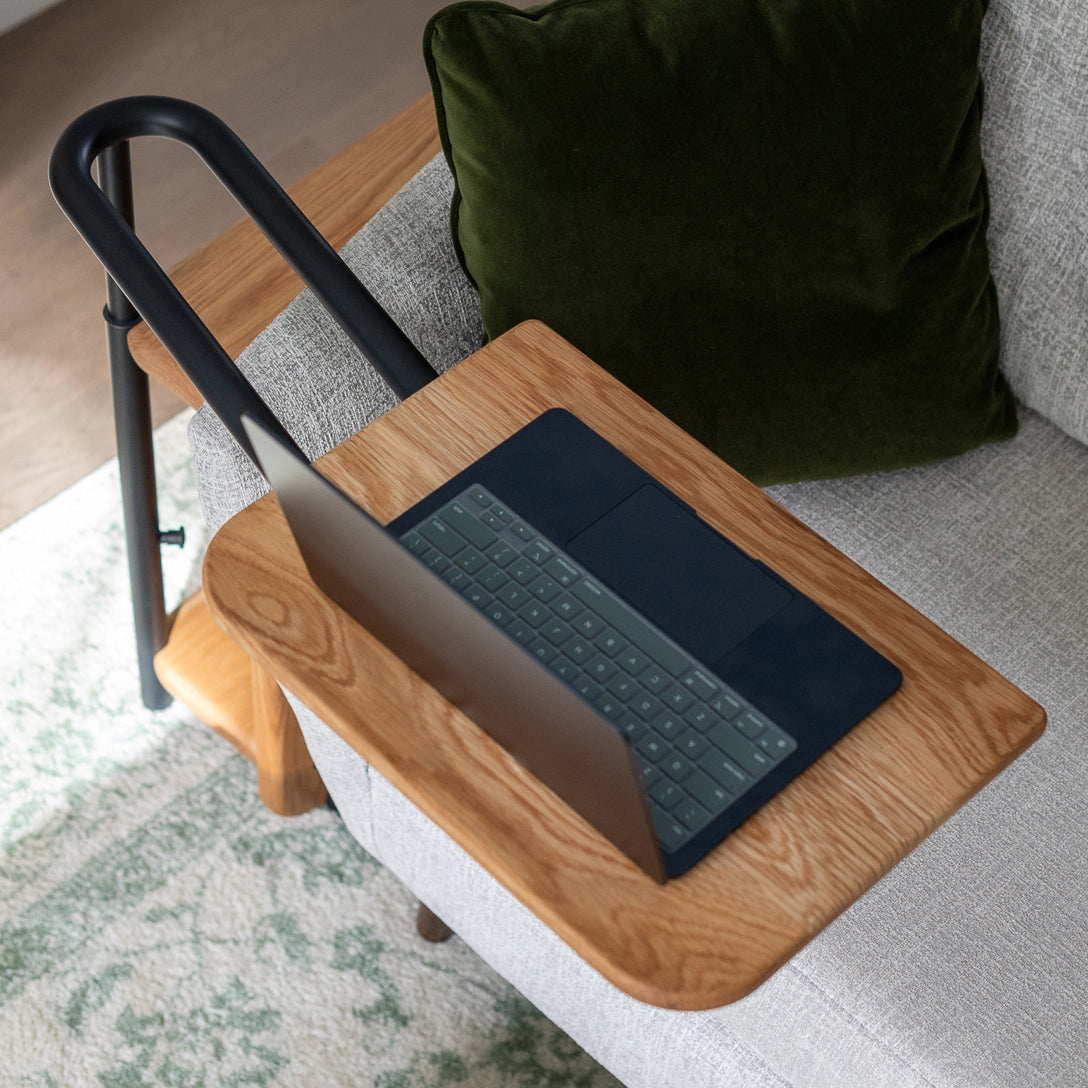 Top-down view of the Corbel Adjustable Side Table tray with an open laptop on it.