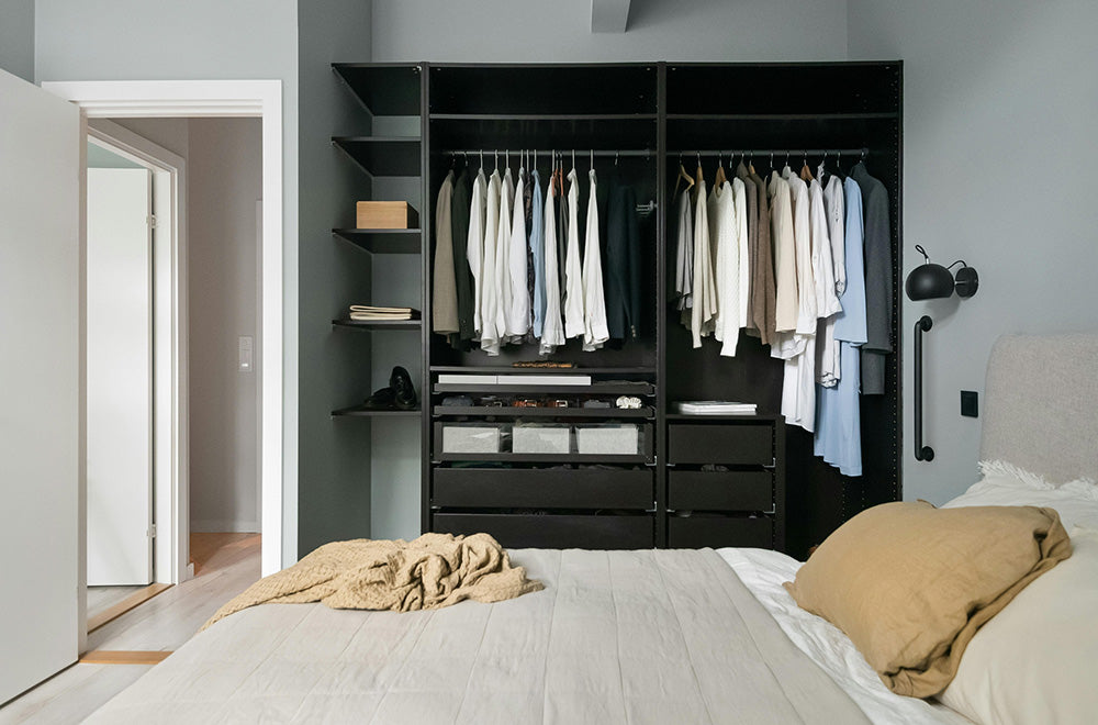 A modern bedroom with a subtle grab bar mounted for balance beside the closet