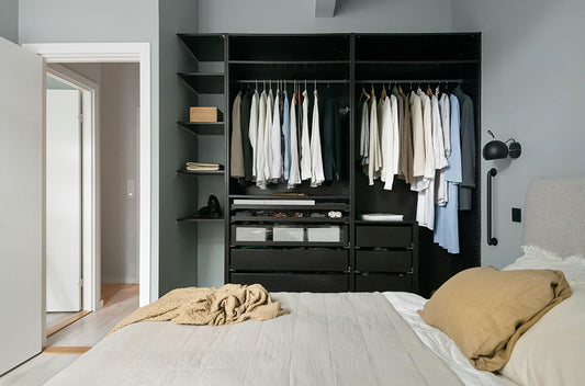 A modern bedroom with a subtle grab bar mounted for balance beside the closet