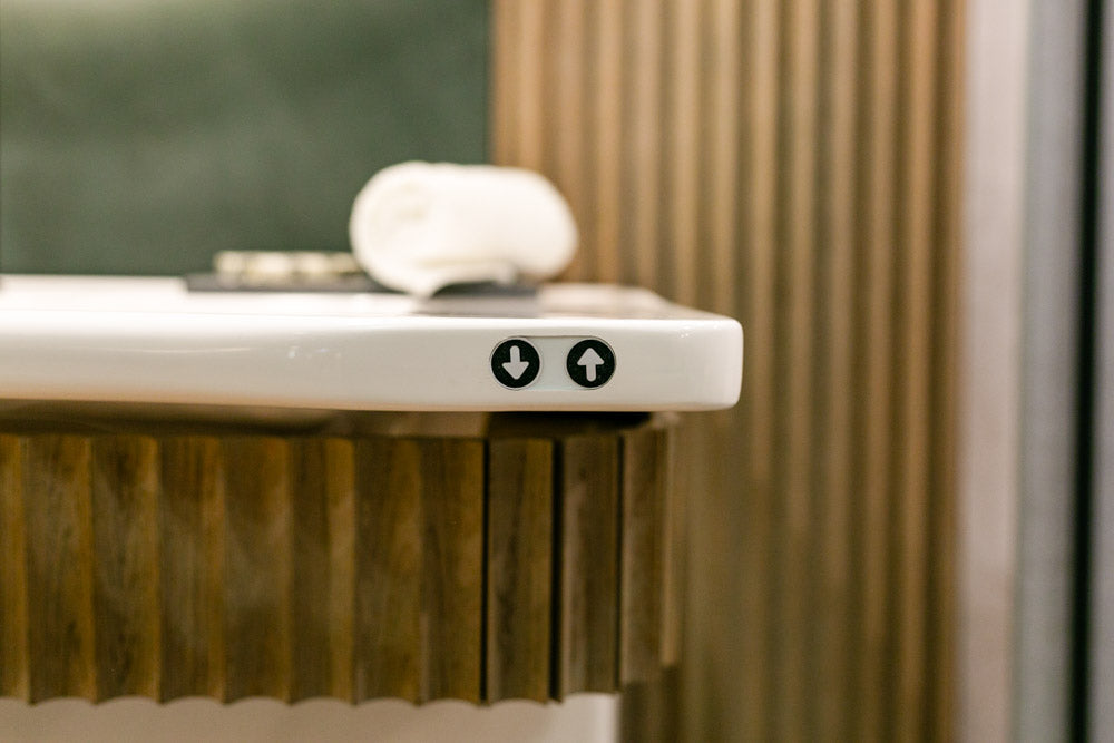 Close-up of an adjustable sink with control buttons on a blurred background