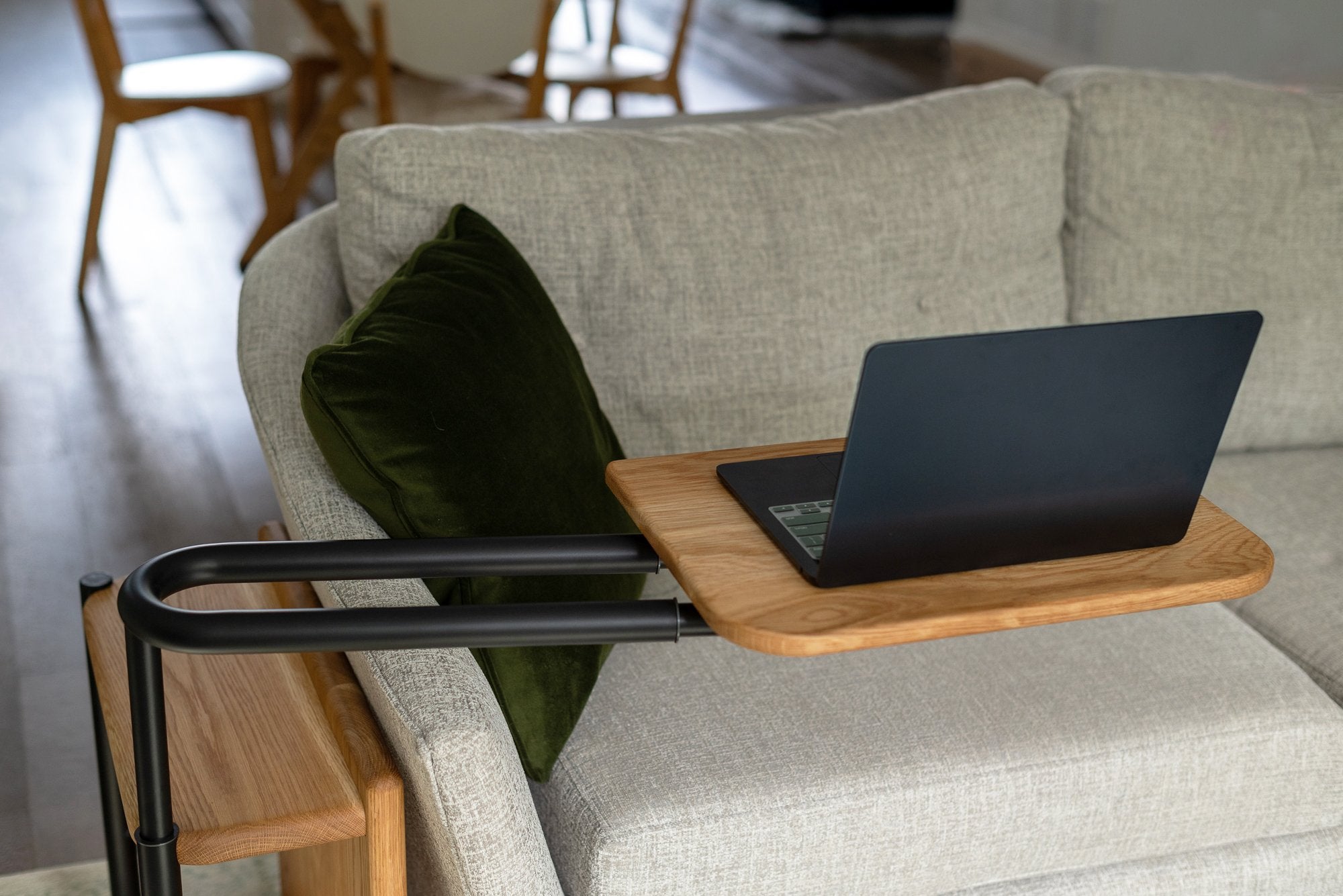 Front view of the Corbel Adjustable Side Table tray with an open laptop on it.