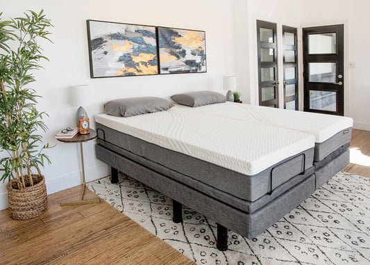 Gray adjustable bed in a bedroom setting with decor elements.