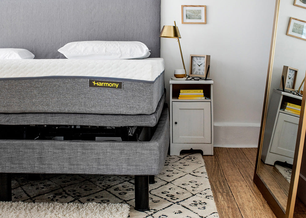 Gray mattress with 'Harmony' branding in a bedroom setting.