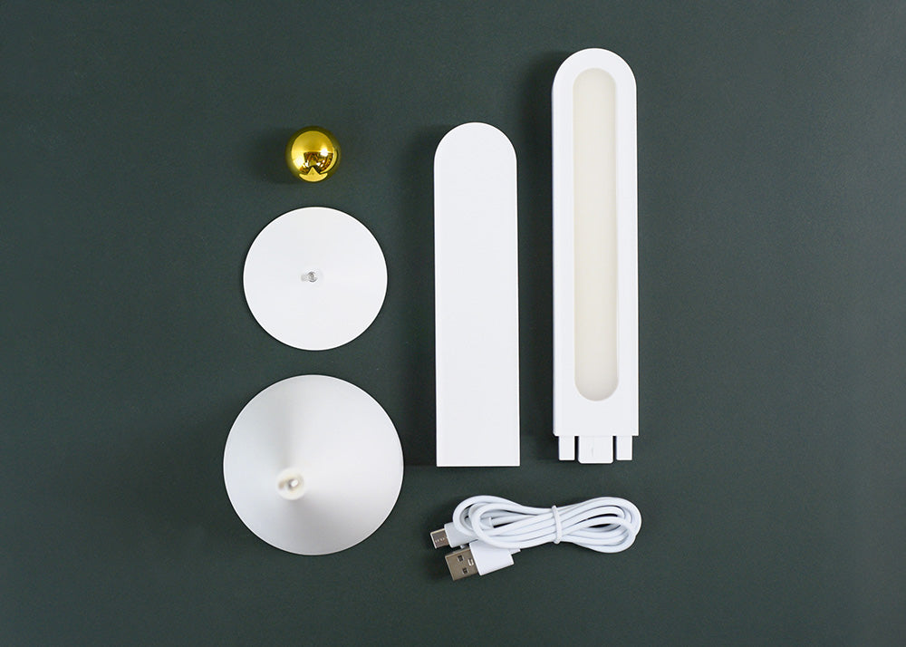 Set of white electronic components and a USB cable on a dark gray background