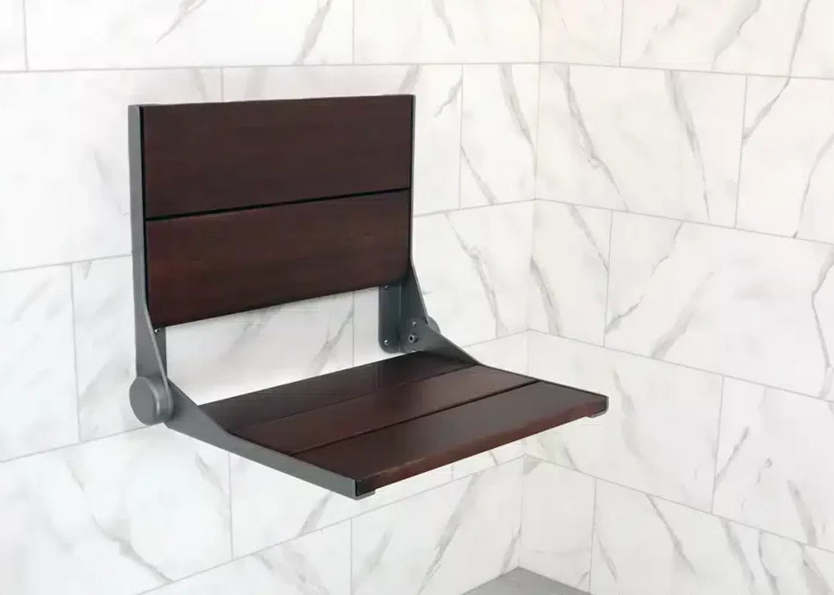 Wooden folding shower seat against a tiled wall