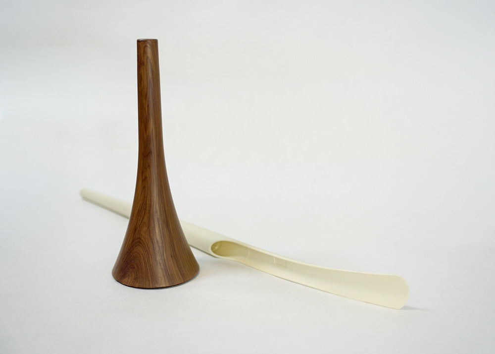 Wooden and white shoe horn on a white background