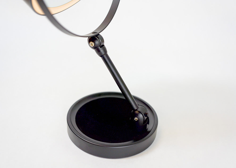 Black mirror with a felted black base on a white background