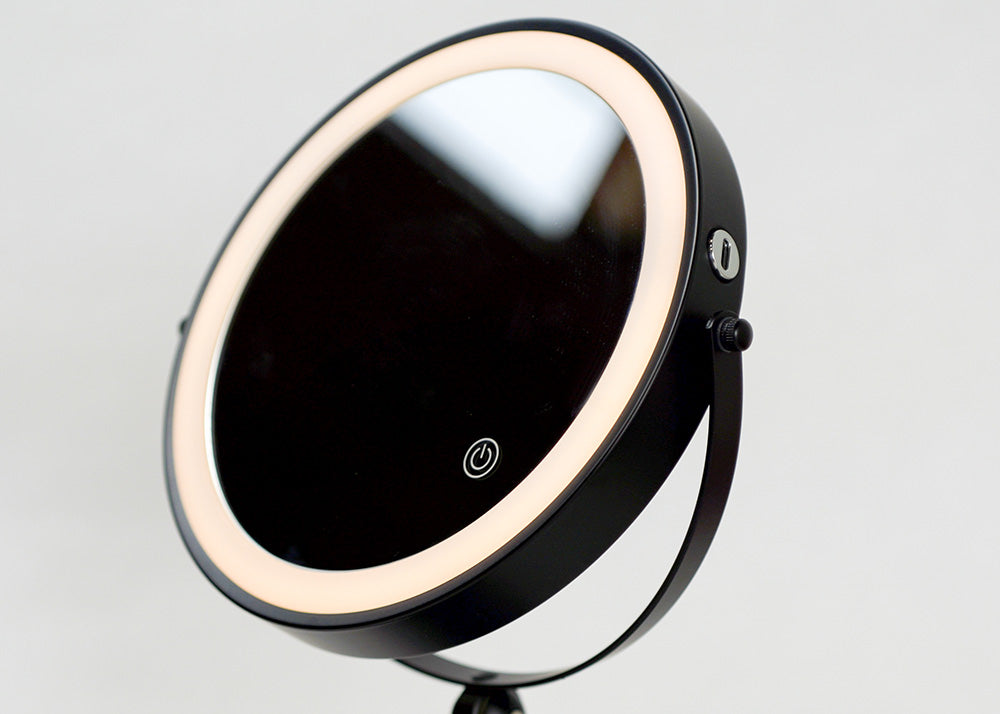 Makeup mirror with LED lights on a gray background